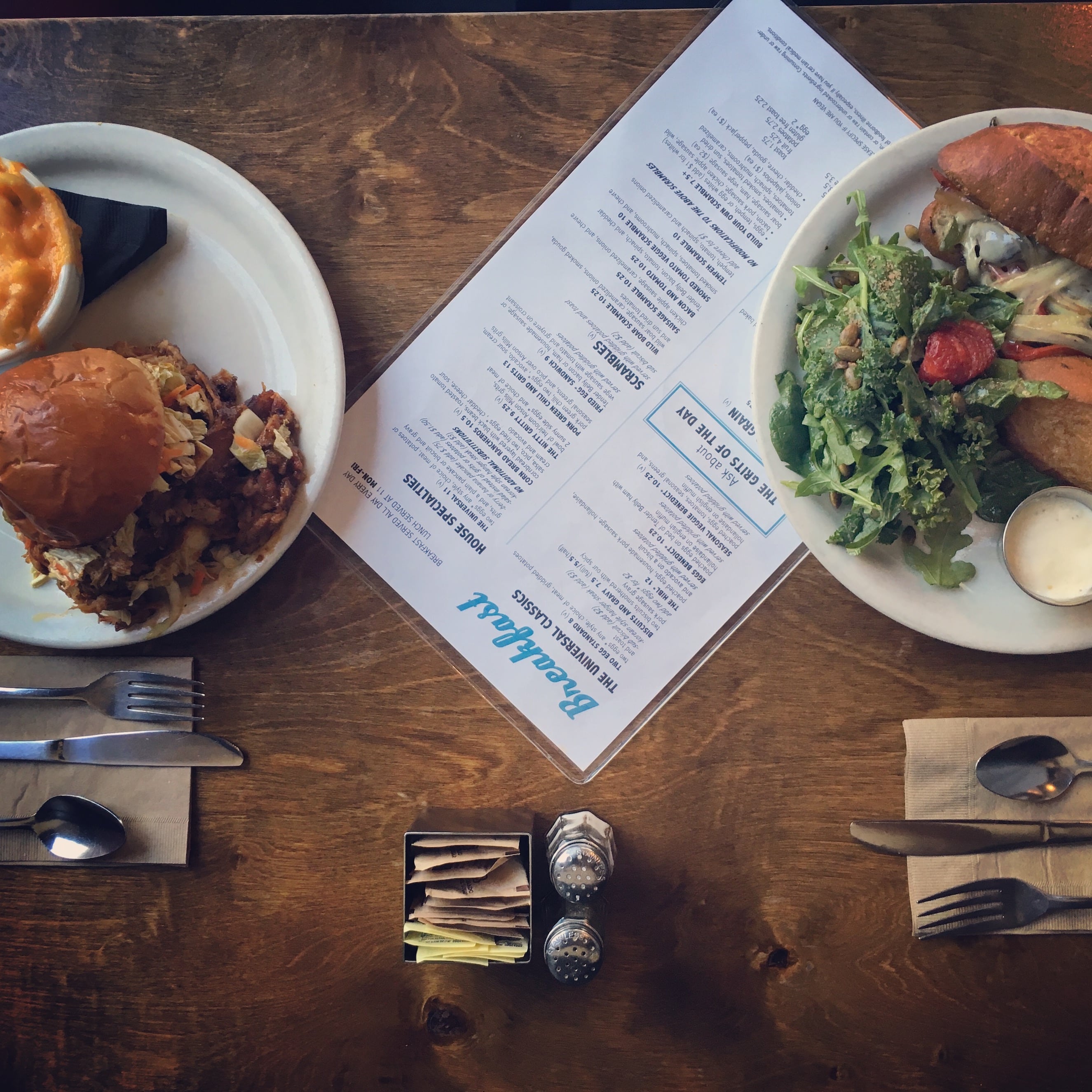 A photograph of great brunch food next to a menu on a table